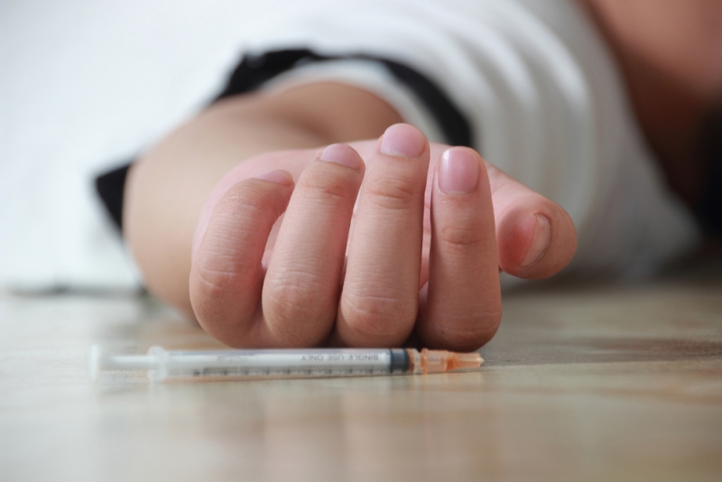 heroin overdose hand syringe