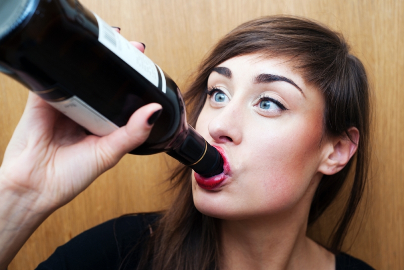 woman chugging wine