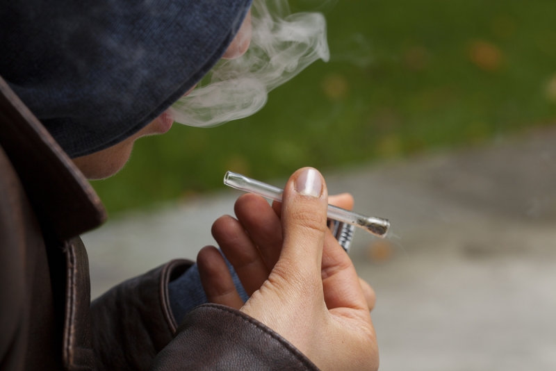 teen boy smoking pipe