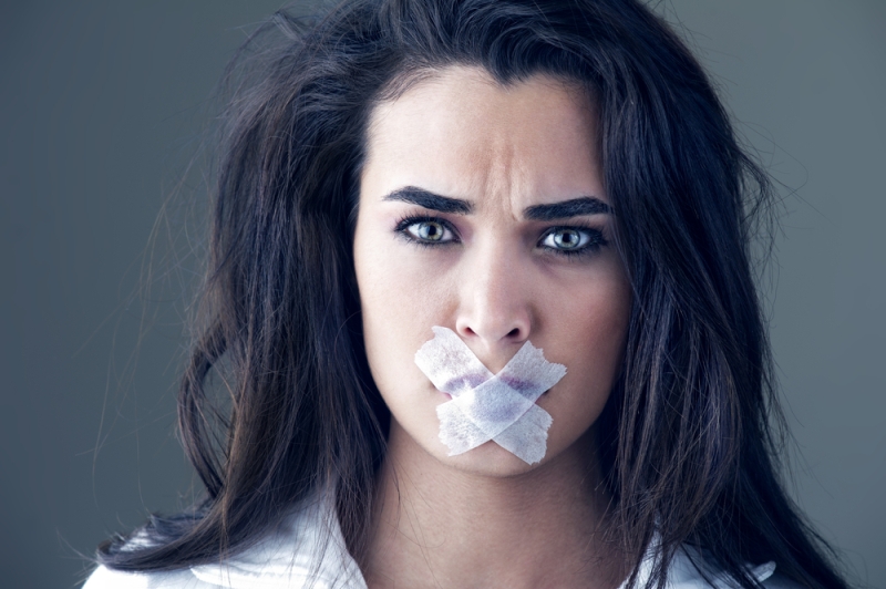 woman taped mouth silenced