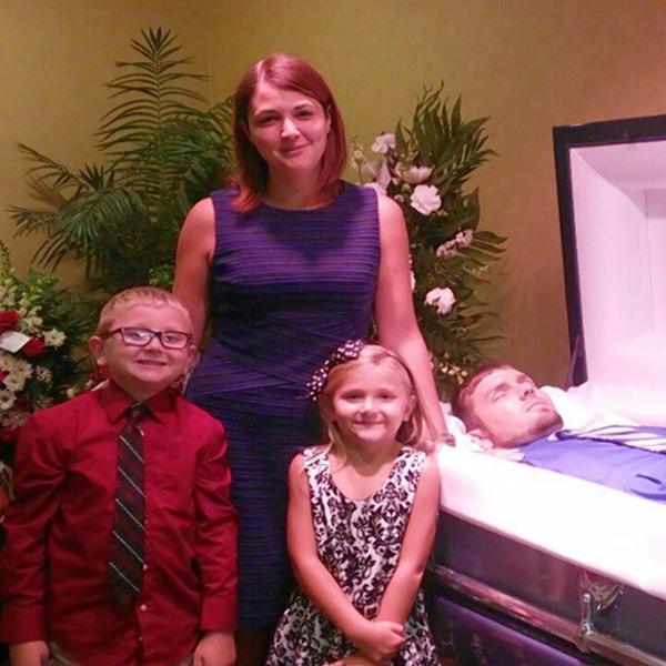 family posing with dead father