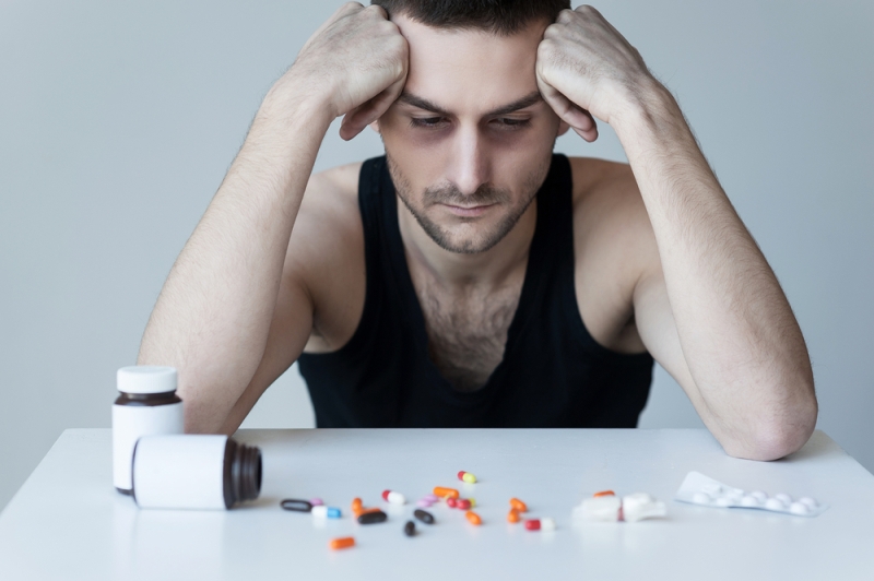 man suffering pill addiction