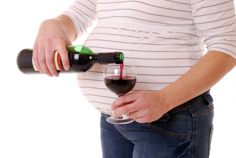 pregnant woman pouring wine