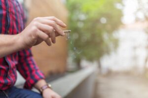 man smoking joint outside