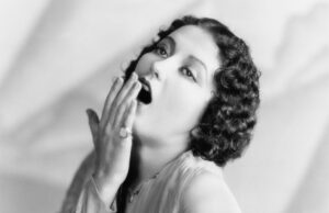 A woman yawning.