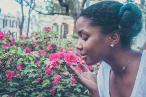 woman smelling flower