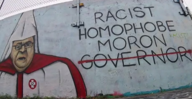 LePage mural saying Racist, Homophobe, Moron, with Governor crossed out