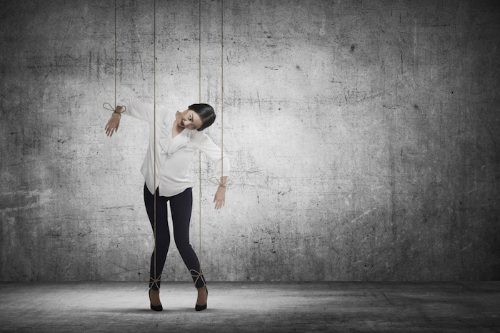 woman on marionette strings.