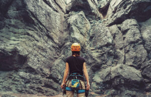 Woman preparing to rock-climb.