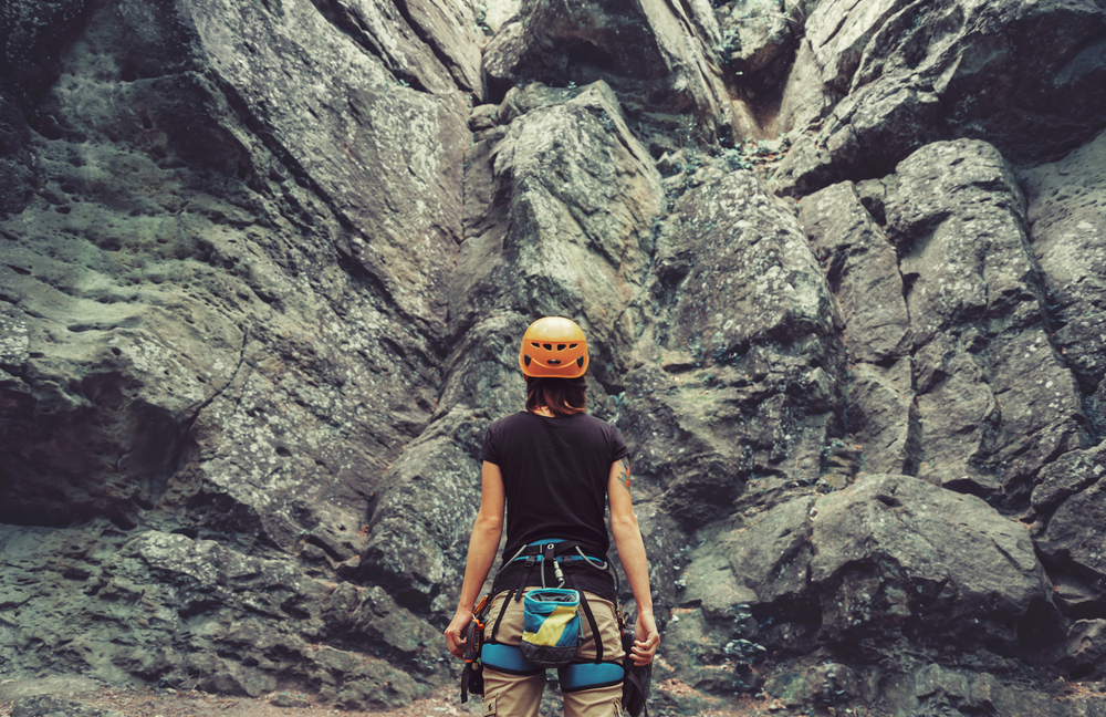 Woman preparing to rock-climb.