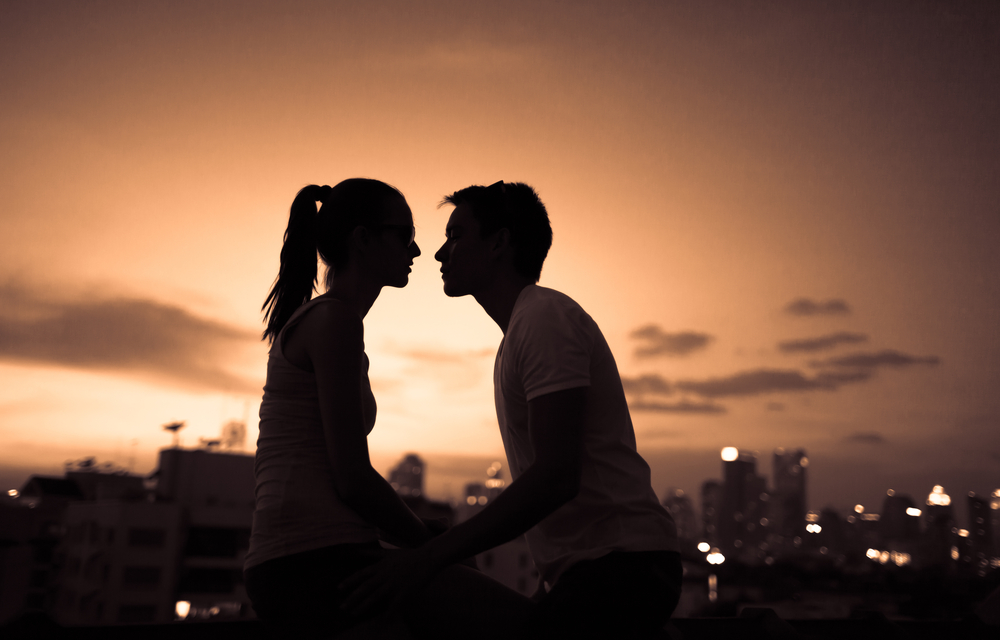 Silhouette of a man and woman in front of a sunset