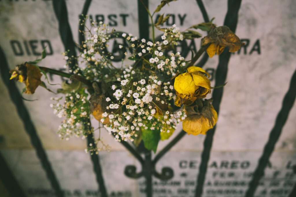 A grave with yellow flowers