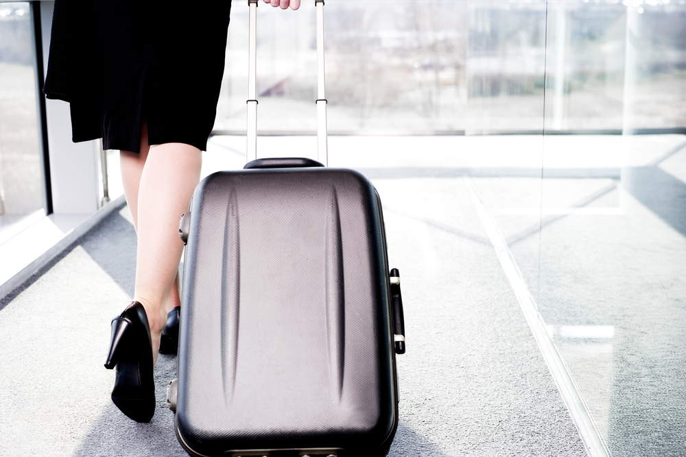 Woman with suitcase at airport.