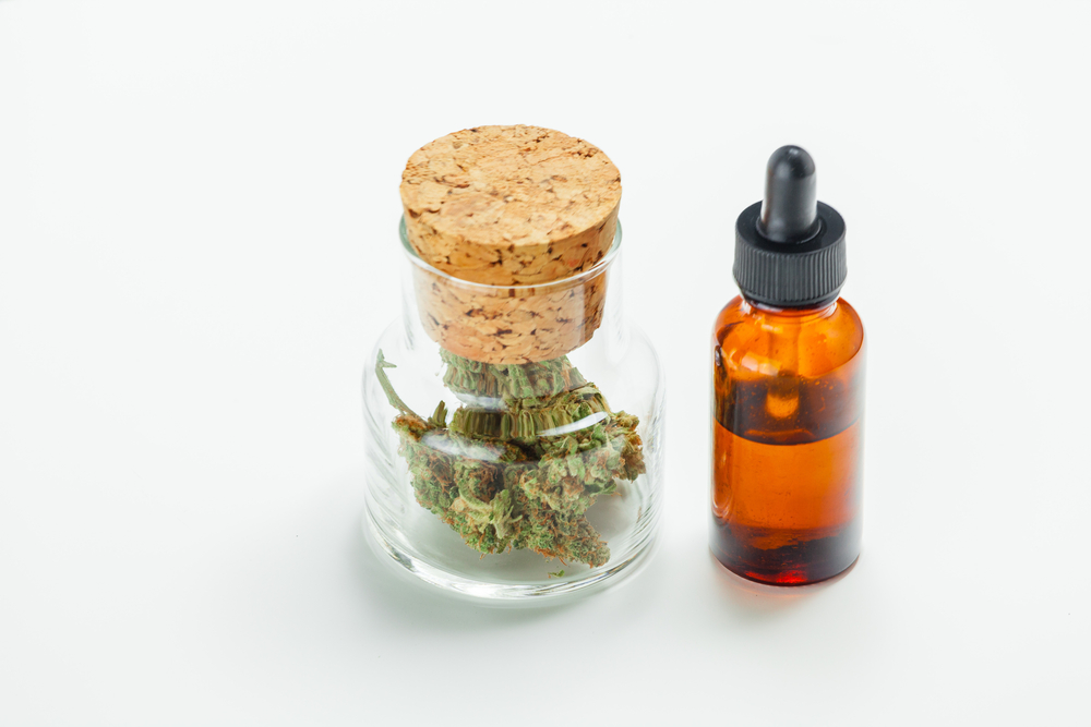 Medical marijuana In Glass Jar And Cannabis Oil Extract In Bottle