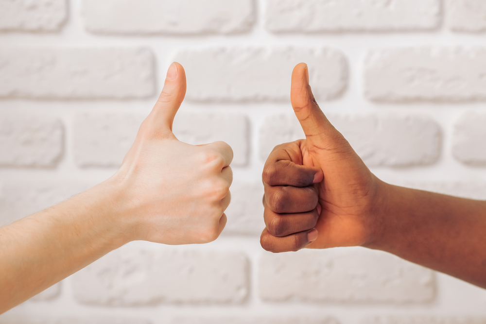 Two hands giving the thumbs up sign