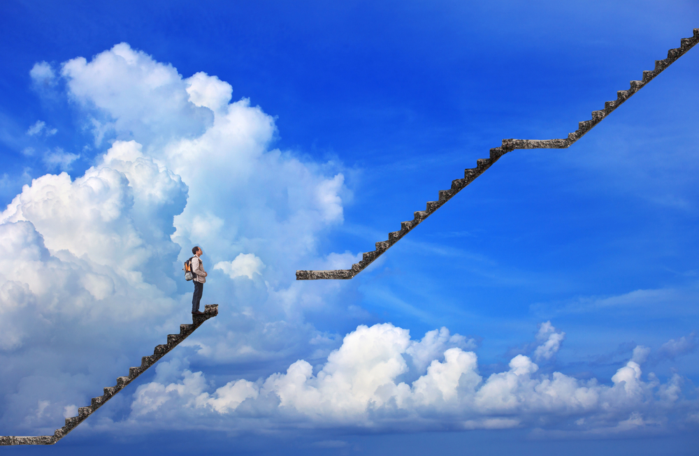 A broken stairway in front of a cloudy sky.