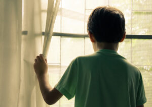 Boy looking out of window.