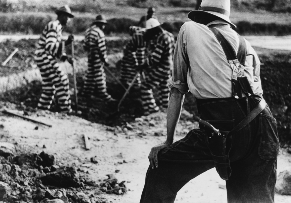 Black and white image of prisoners on a chain gang.