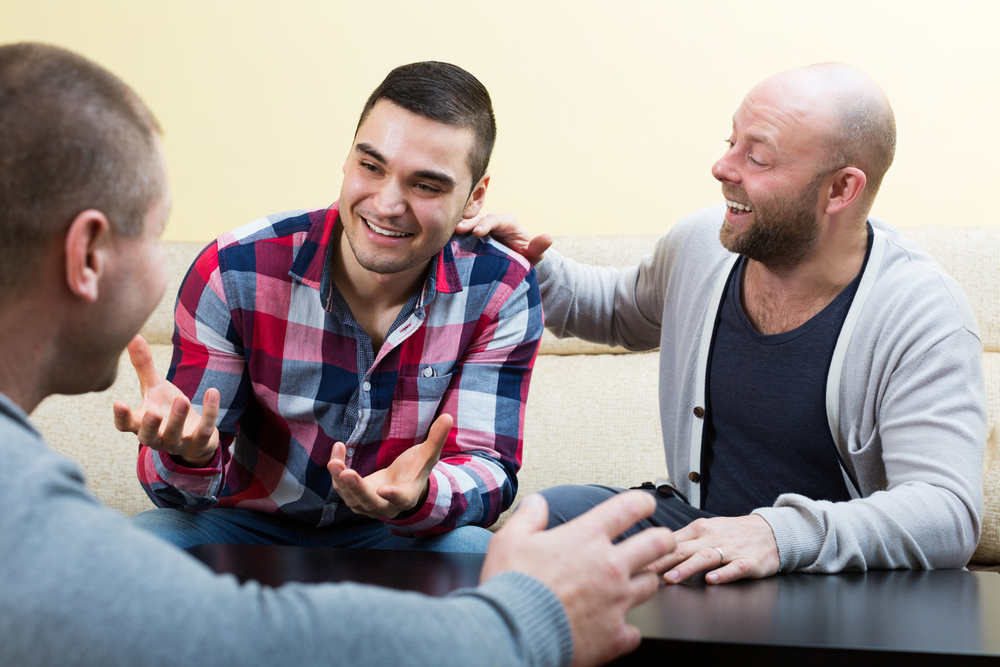 3 young men talking and laughing