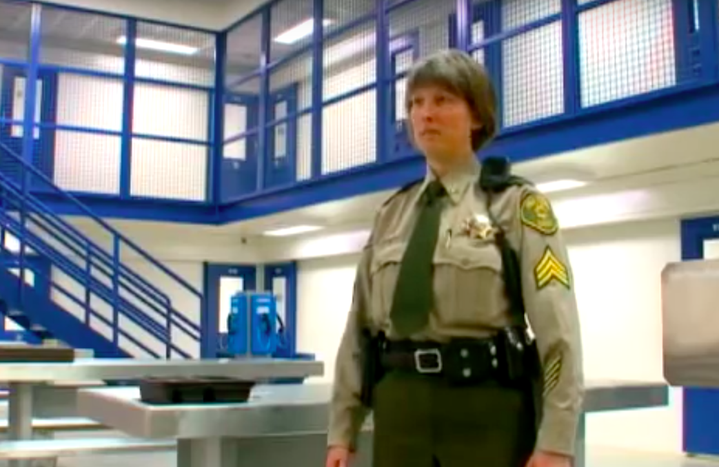Officer giving a tour of the Polk County Jail in Iowa.