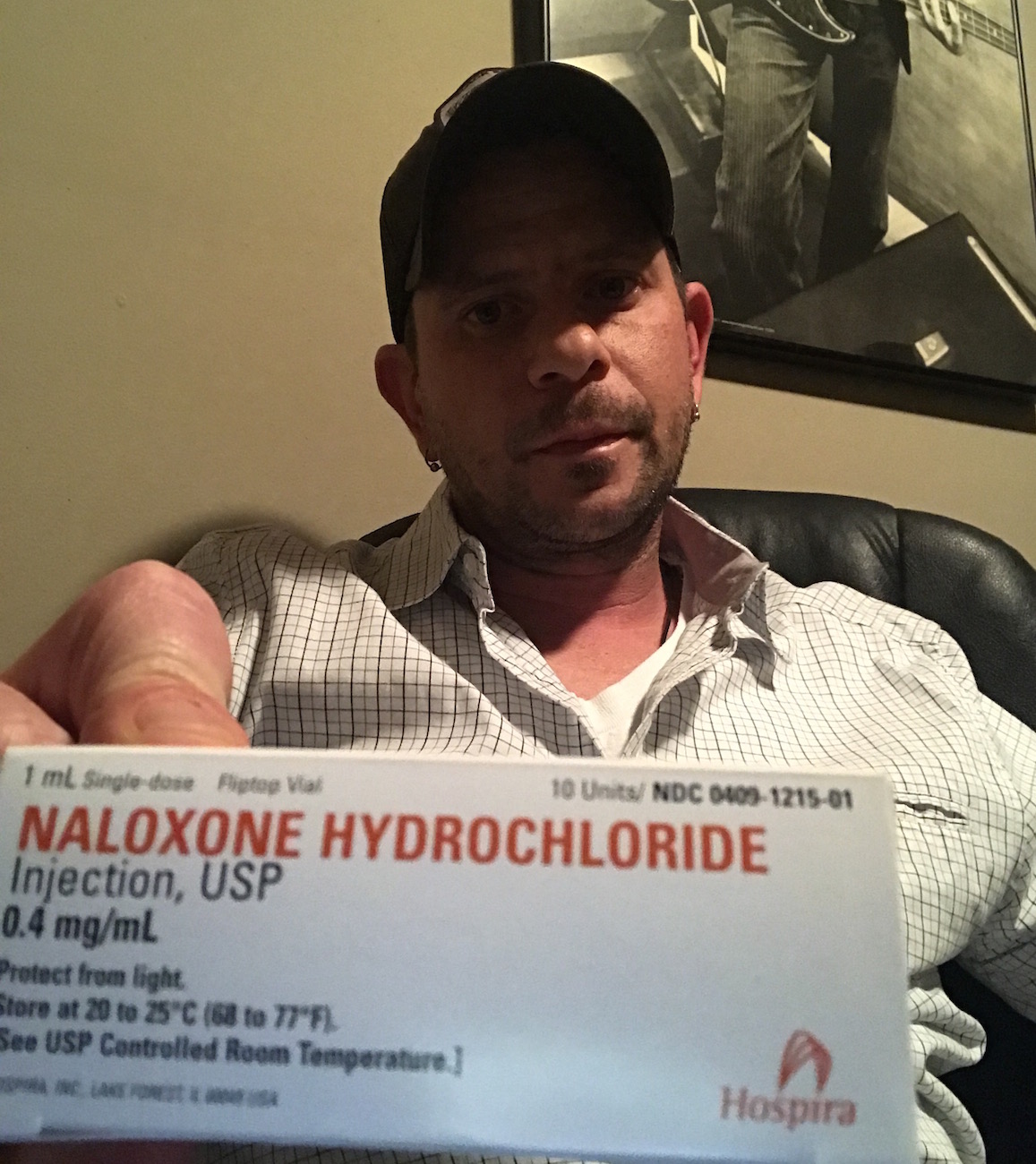 Chad Sabora holding a box labeled Naloxone Hydrochloride