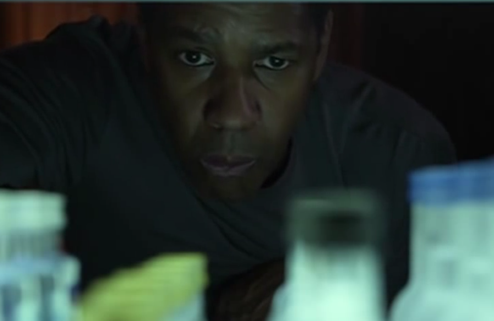 William Whitaker (Denzel Washington) looks at a mini bar in Flight.