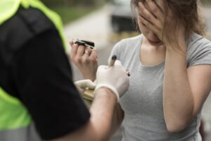 Woman being reprimanded by police officer.