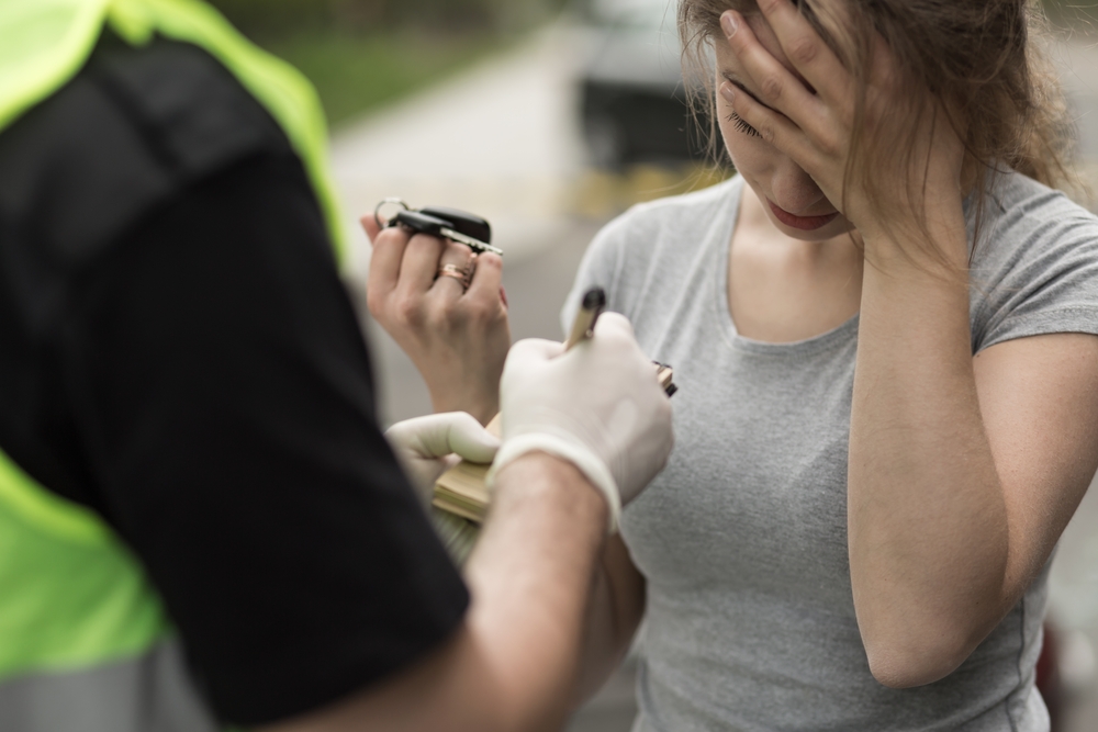 Woman being reprimanded by police officer.