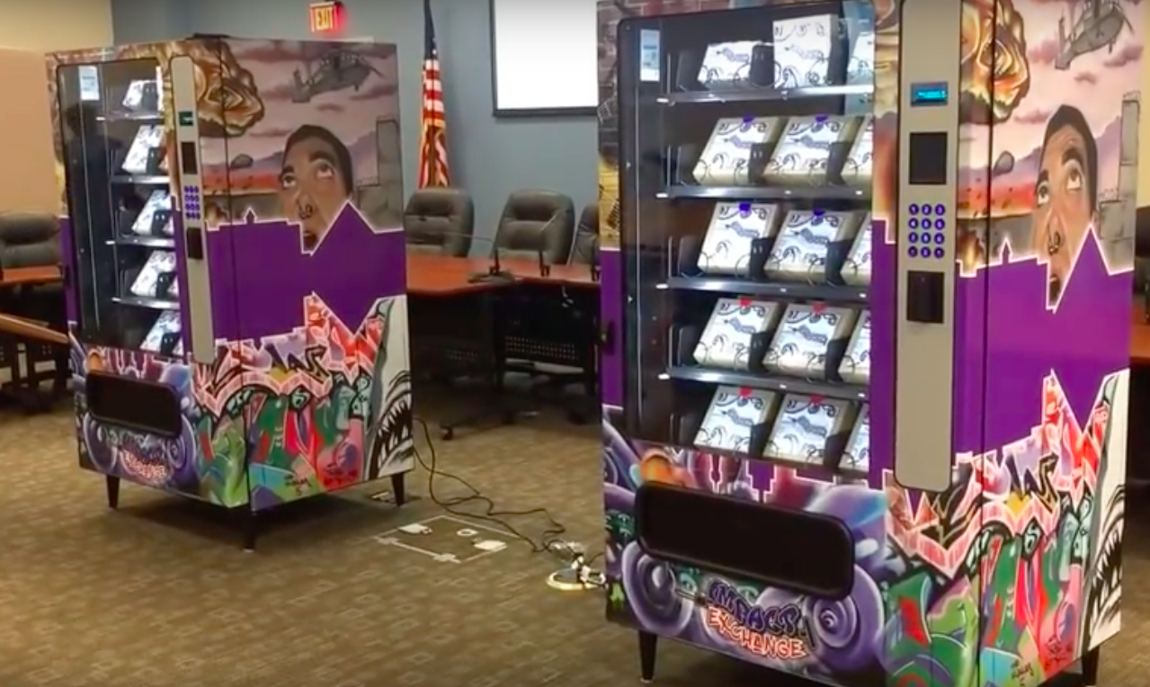 Two syringe vending machines on display.