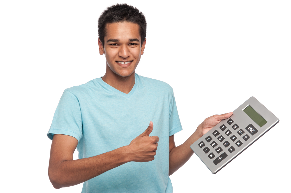 Successful happy young man or teenager with big calculator.