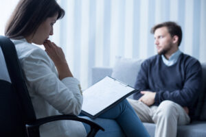 A man talkin to his psychiatrist during a session.