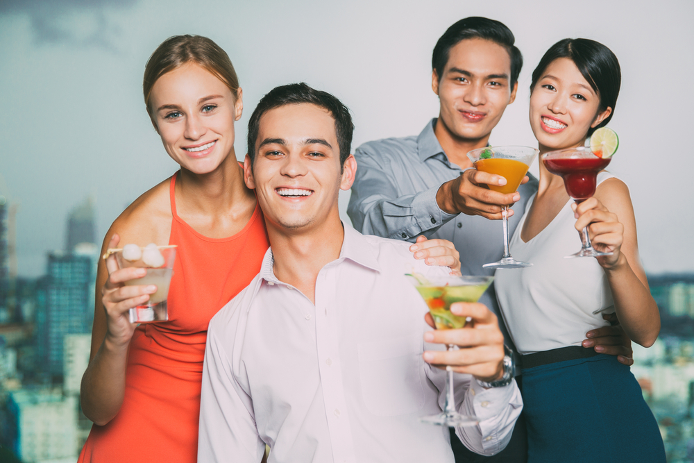 Friends raising glasses, offering drinks.