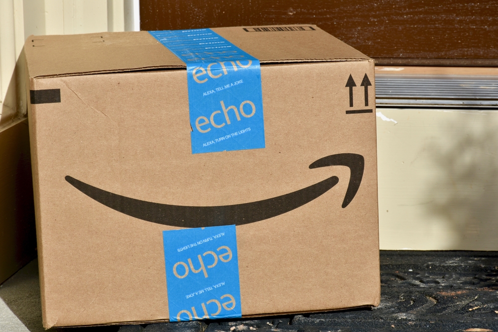 An Amazon box sitting on a door step.