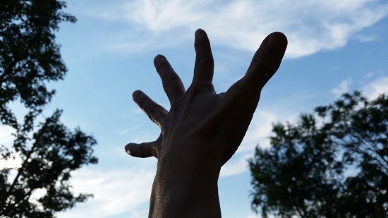 hand reaching out into the sky