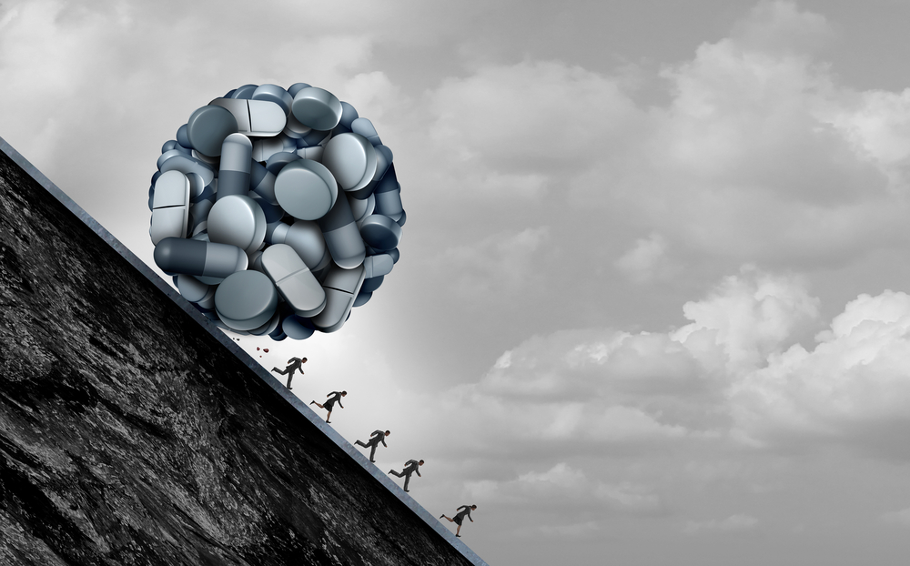 people running downhill away from giant ball of opioids