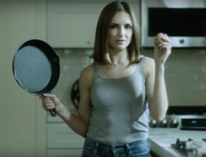 Rachel Leigh Cook holding an egg and a frying pan in new PSA
