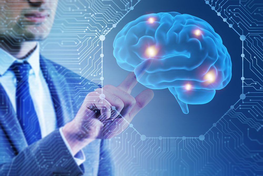 Man in suit pointing to a 3d rendering of a human brain