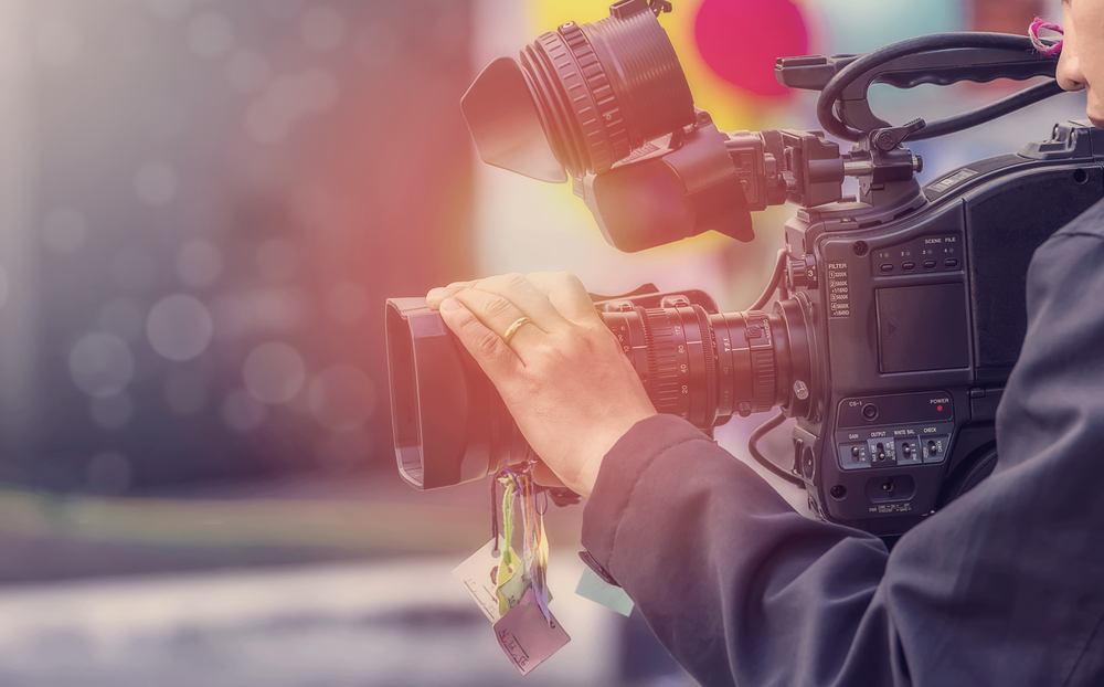 cameraman holding onto camera