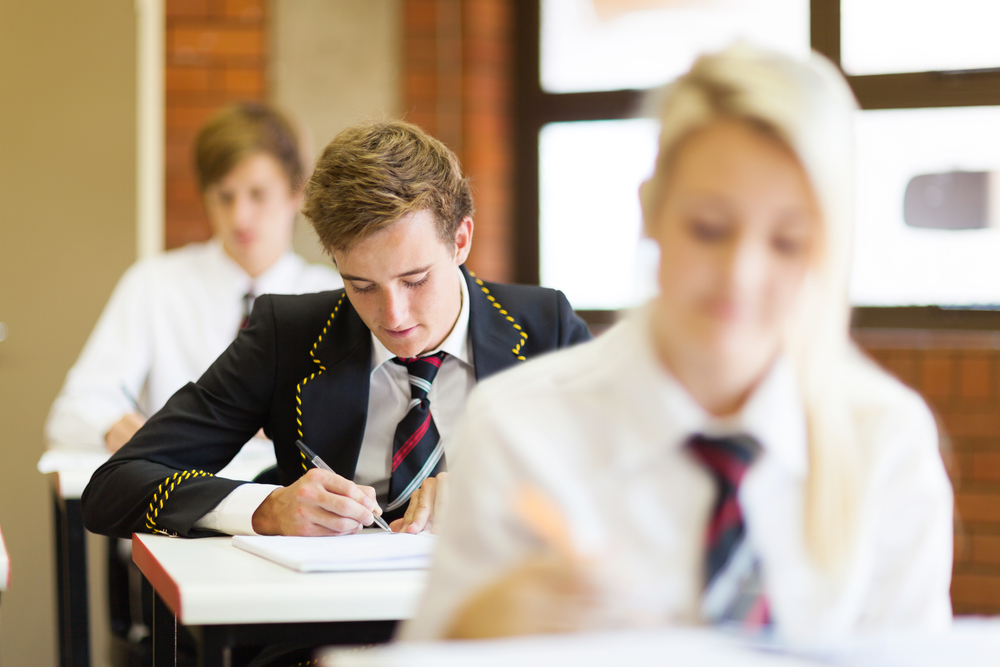 Preparatory high school students sitting inside of a classroom studying.