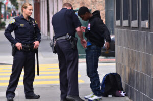 Officers pat down black american man
