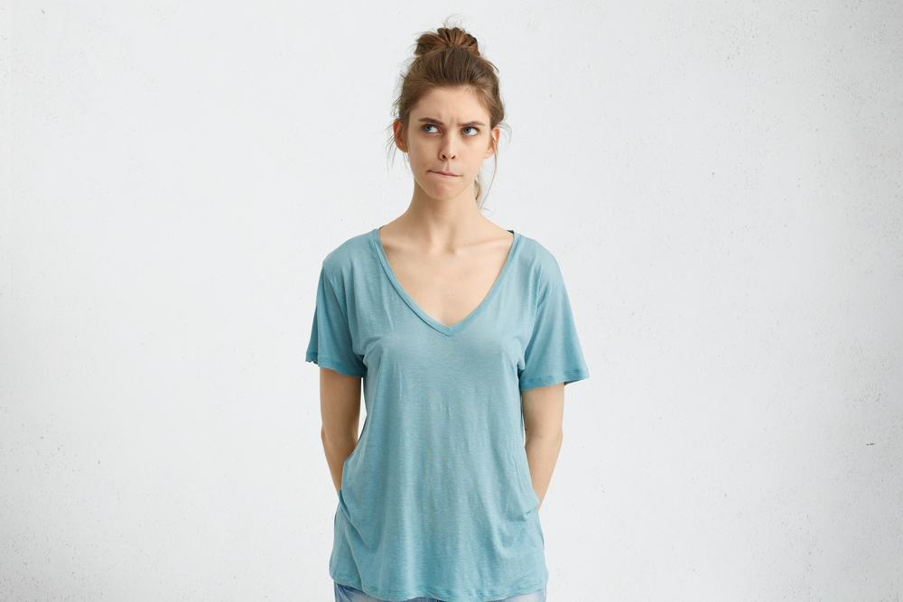 skeptical college female in blue top