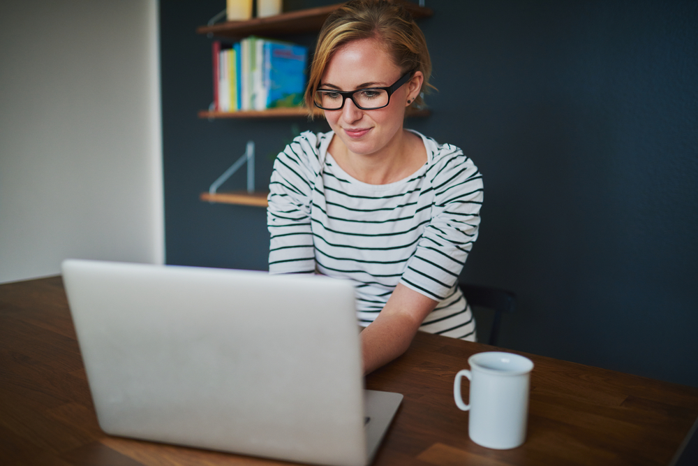 woman sitting in front of laptop in office