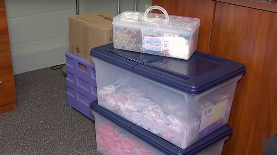 two large containers filled with harm reduction kit materials
