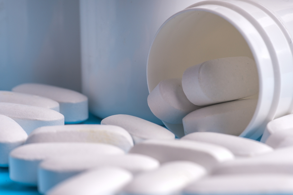 Pills isolated on light blue background.