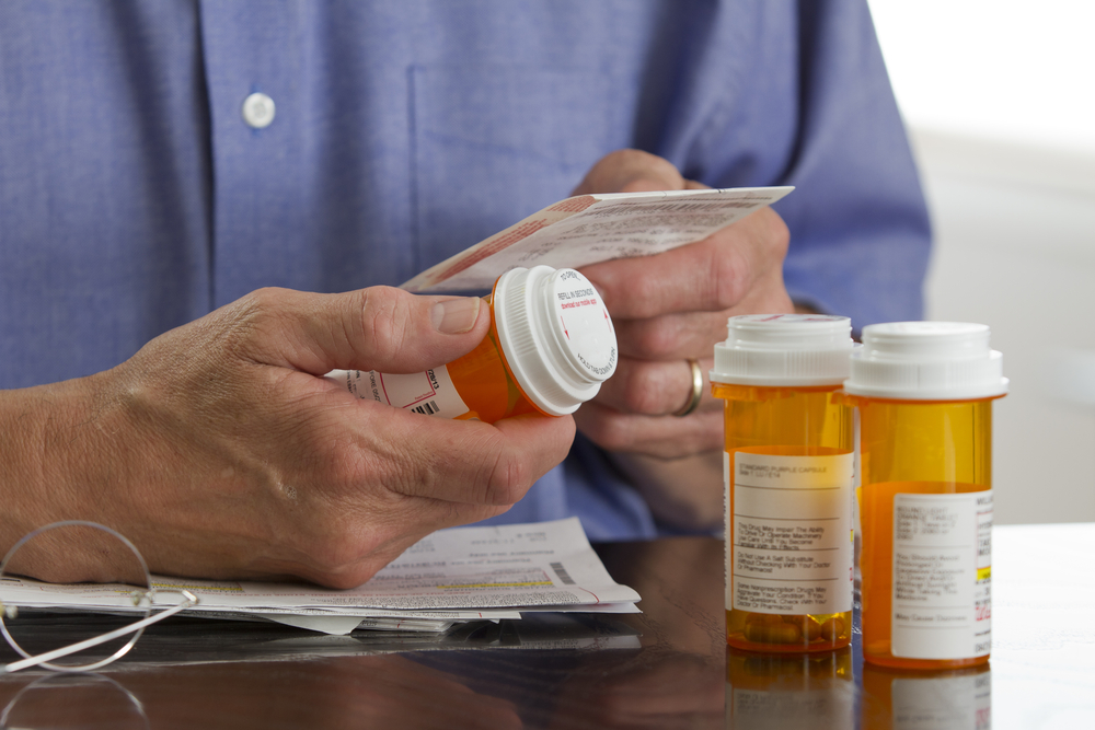 man examining prescription medications.