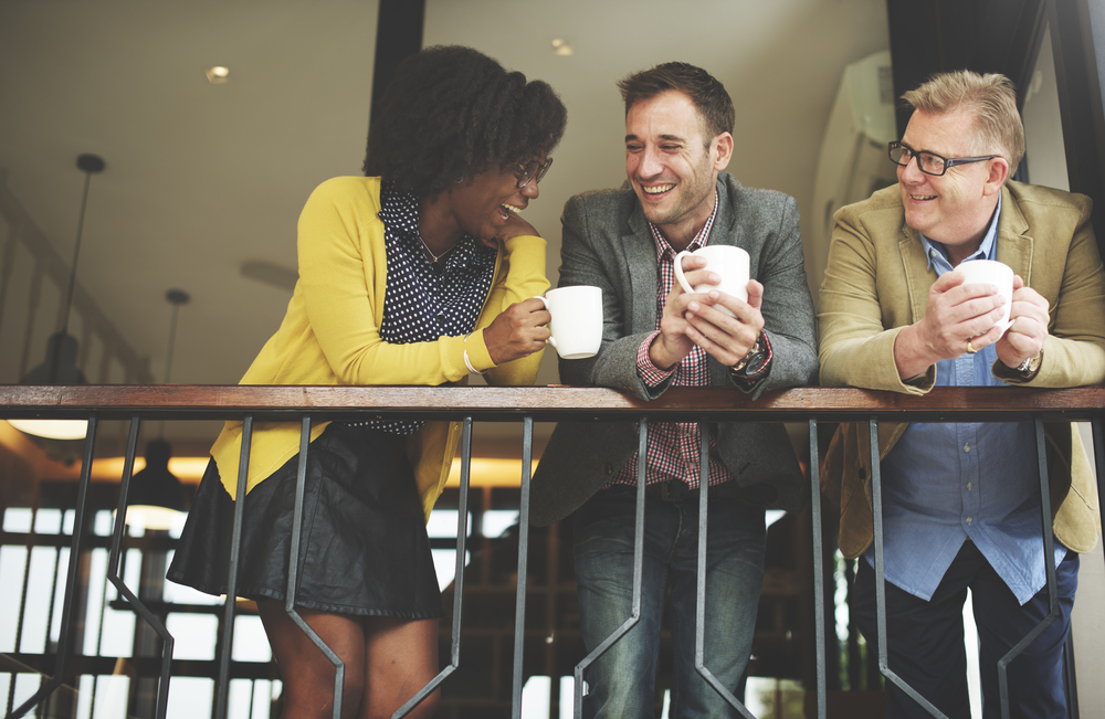 adults chatting on a balcony