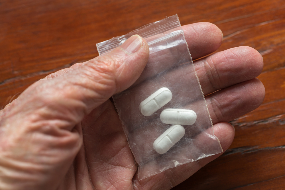 hand holding opioid pills