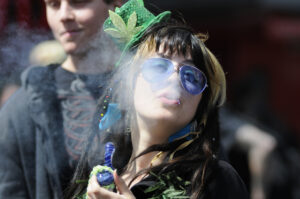 Marijuana smoker blowing out smoke during a street festival