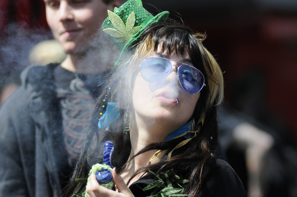 Marijuana smoker blowing out smoke during a street festival