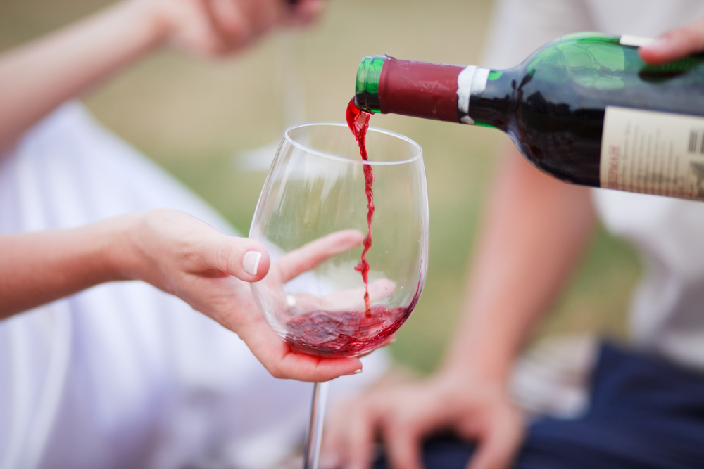 man pouring a glass of red wine